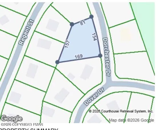 an aerial view of a swimming pool with outdoor seating