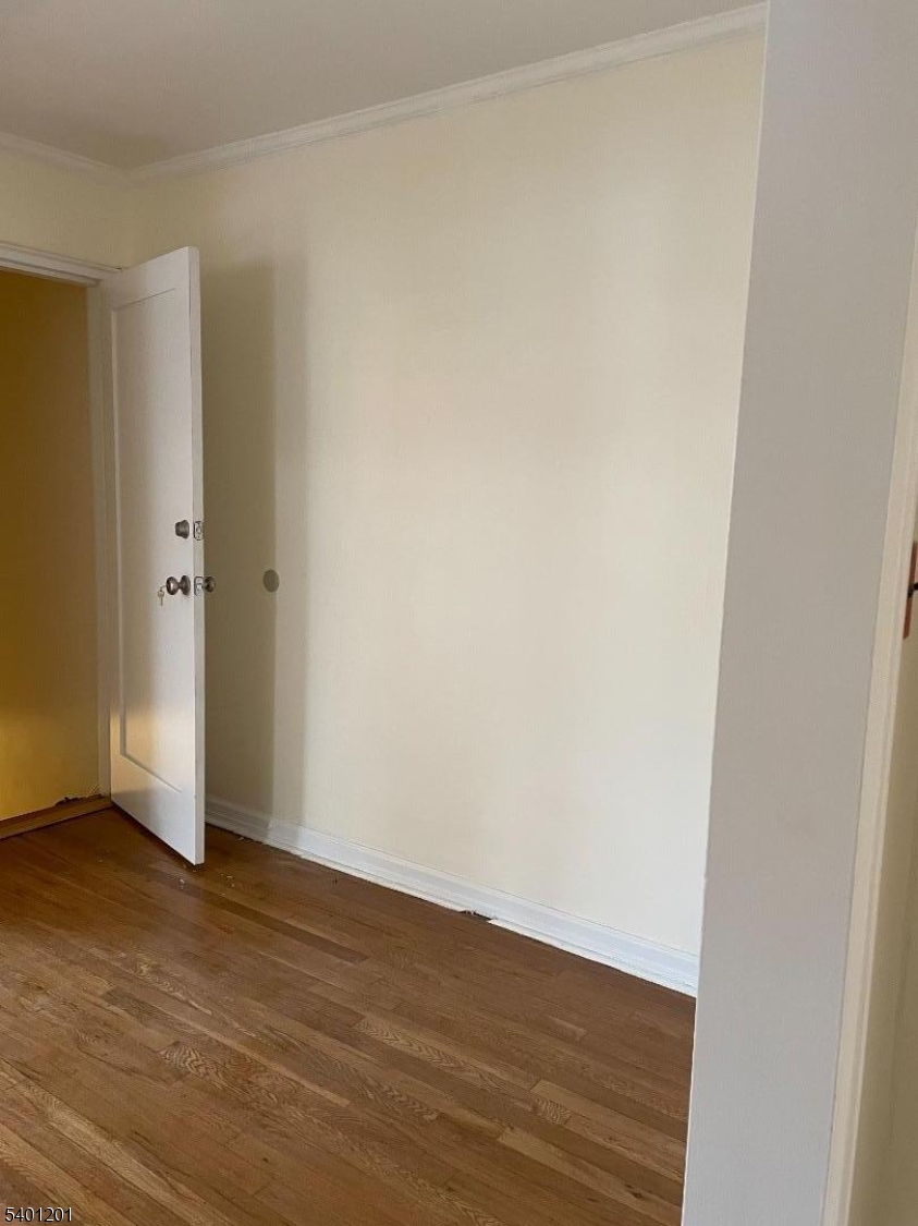 138 Midland Place Newark, NJ 07106 - Photo 3 of 5 a view of an empty room with wooden floor