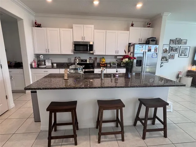 a kitchen with stainless steel appliances a refrigerator sink and cabinets