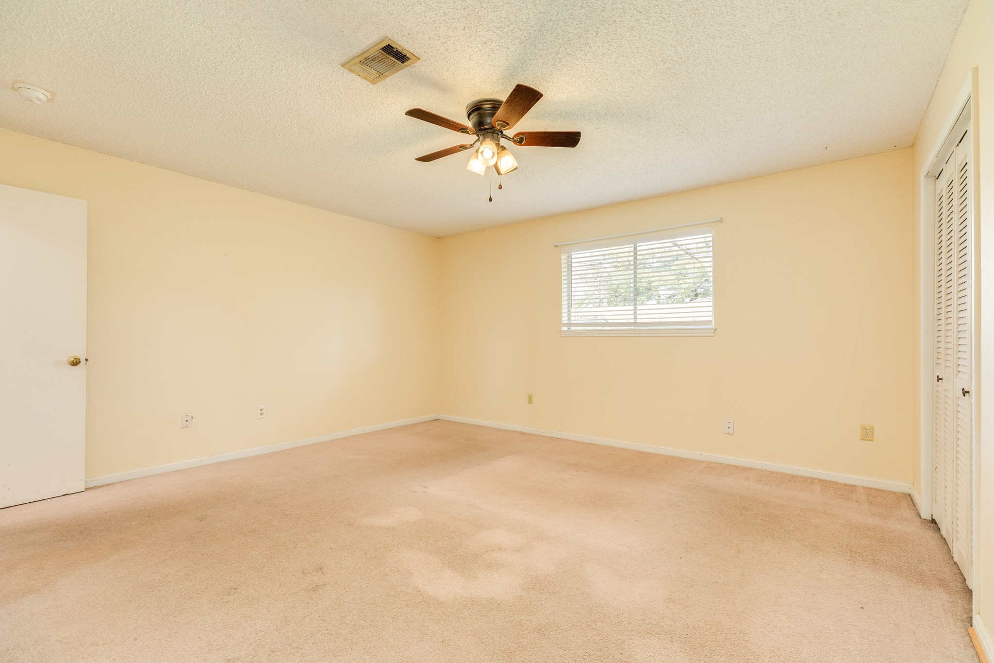1030 Maple Street Clute, TX 77531 - Photo 14 of 25 an empty room with windows and ceiling fan