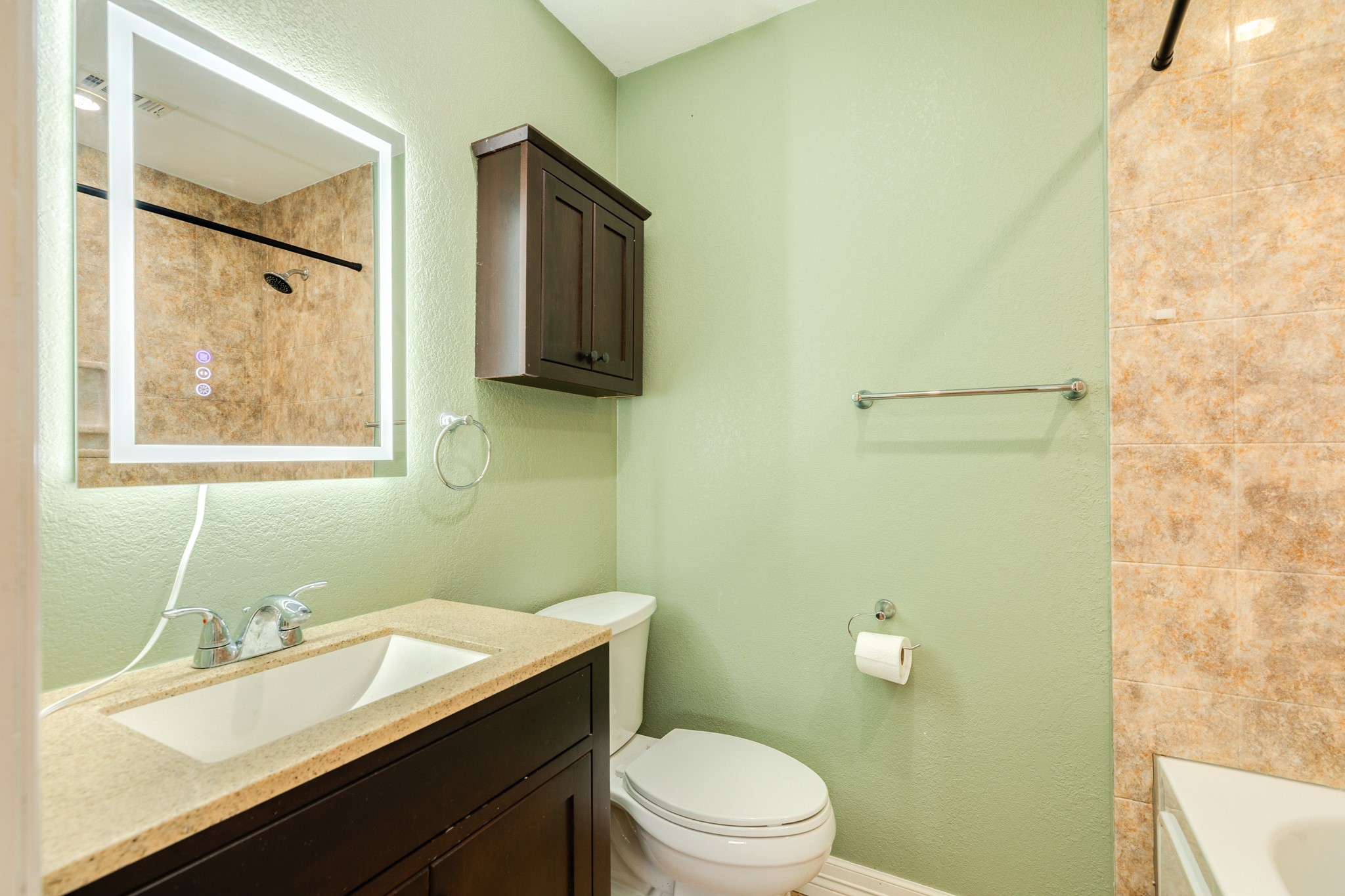 1030 Maple Street Clute, TX 77531 - Photo 17 of 25 a bathroom with a sink vanity mirror and toilet