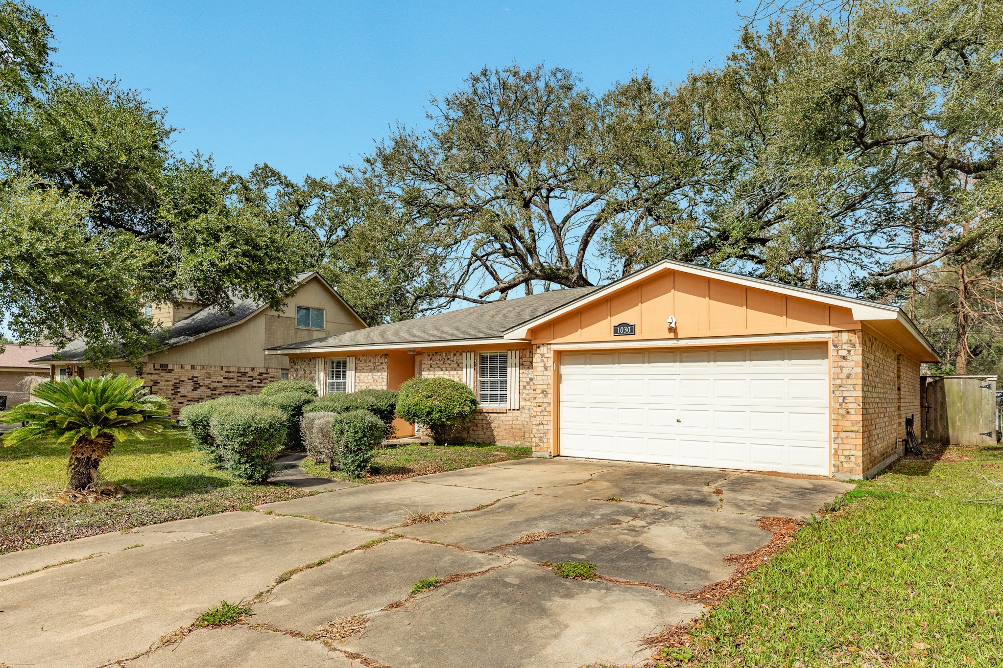 1030 Maple Street Clute, TX 77531 - Photo 2 of 25 a front view of a house with a yard and garage