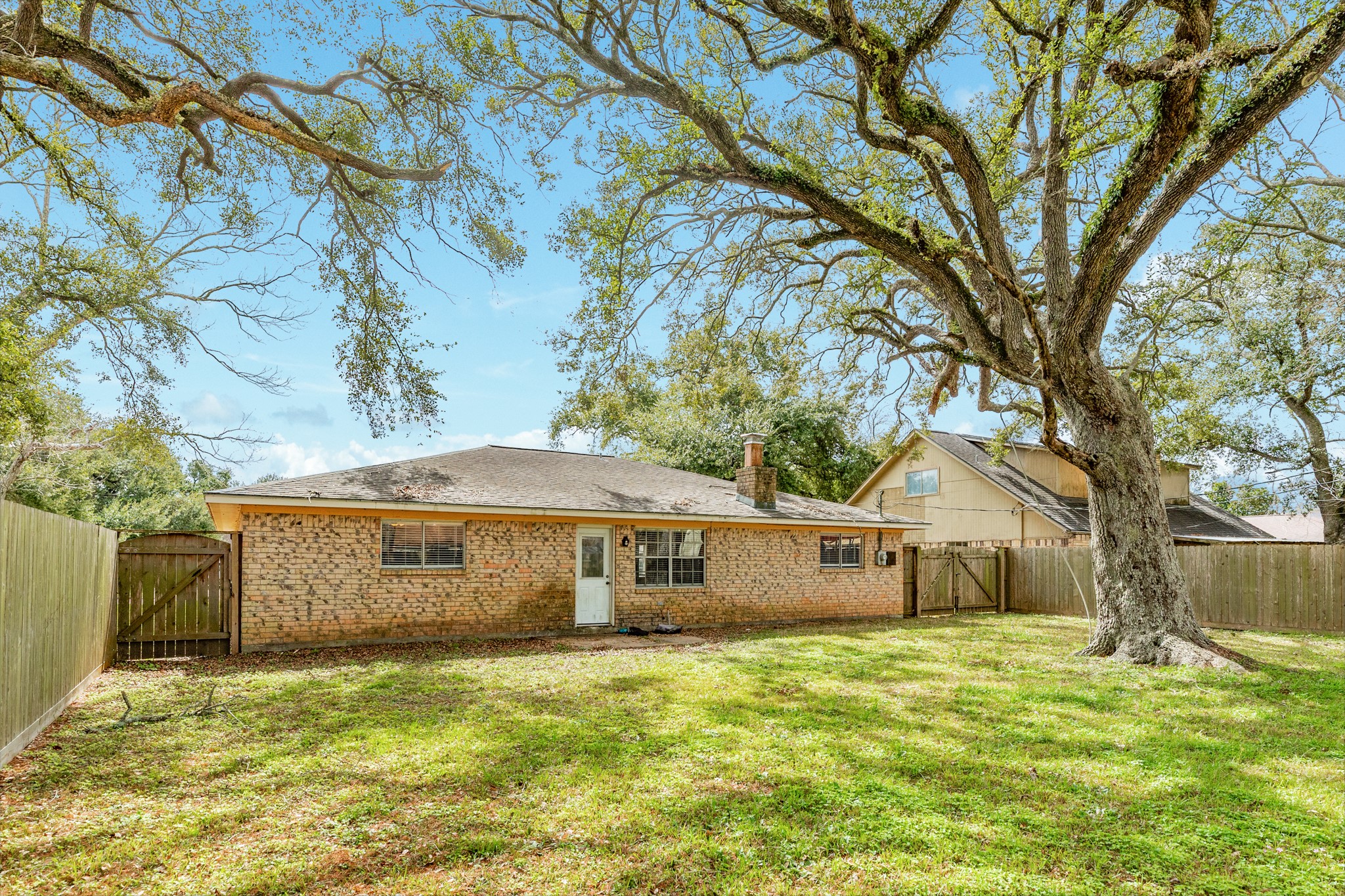 1030 Maple Street Clute, TX 77531 - Photo 22 of 25 a front view of a house with a garden and tree