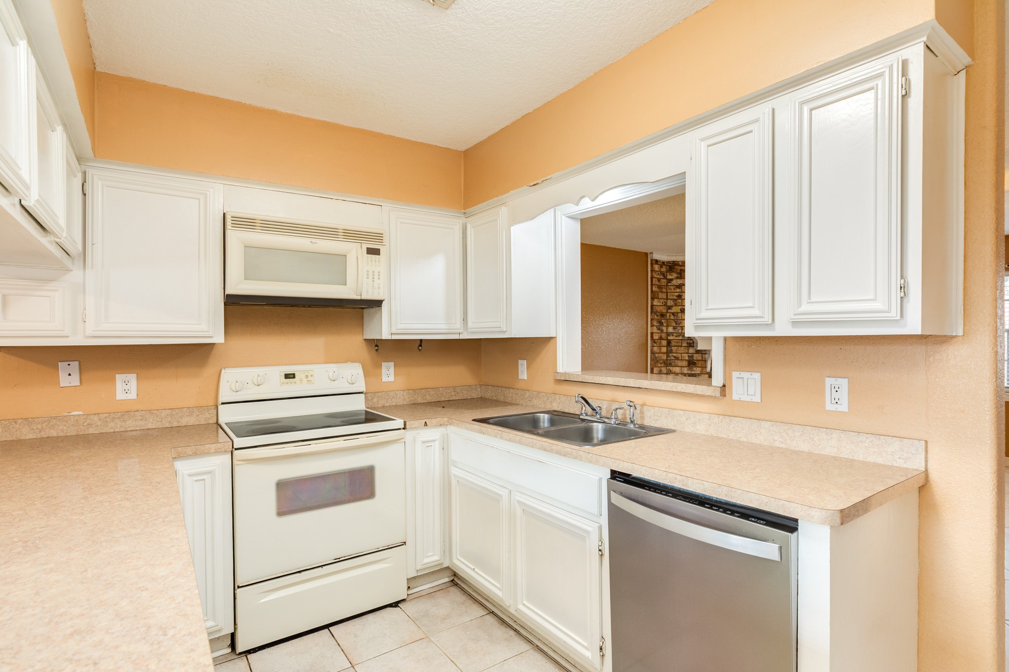 1030 Maple Street Clute, TX 77531 - Photo 8 of 25 a kitchen with white cabinets and white appliances