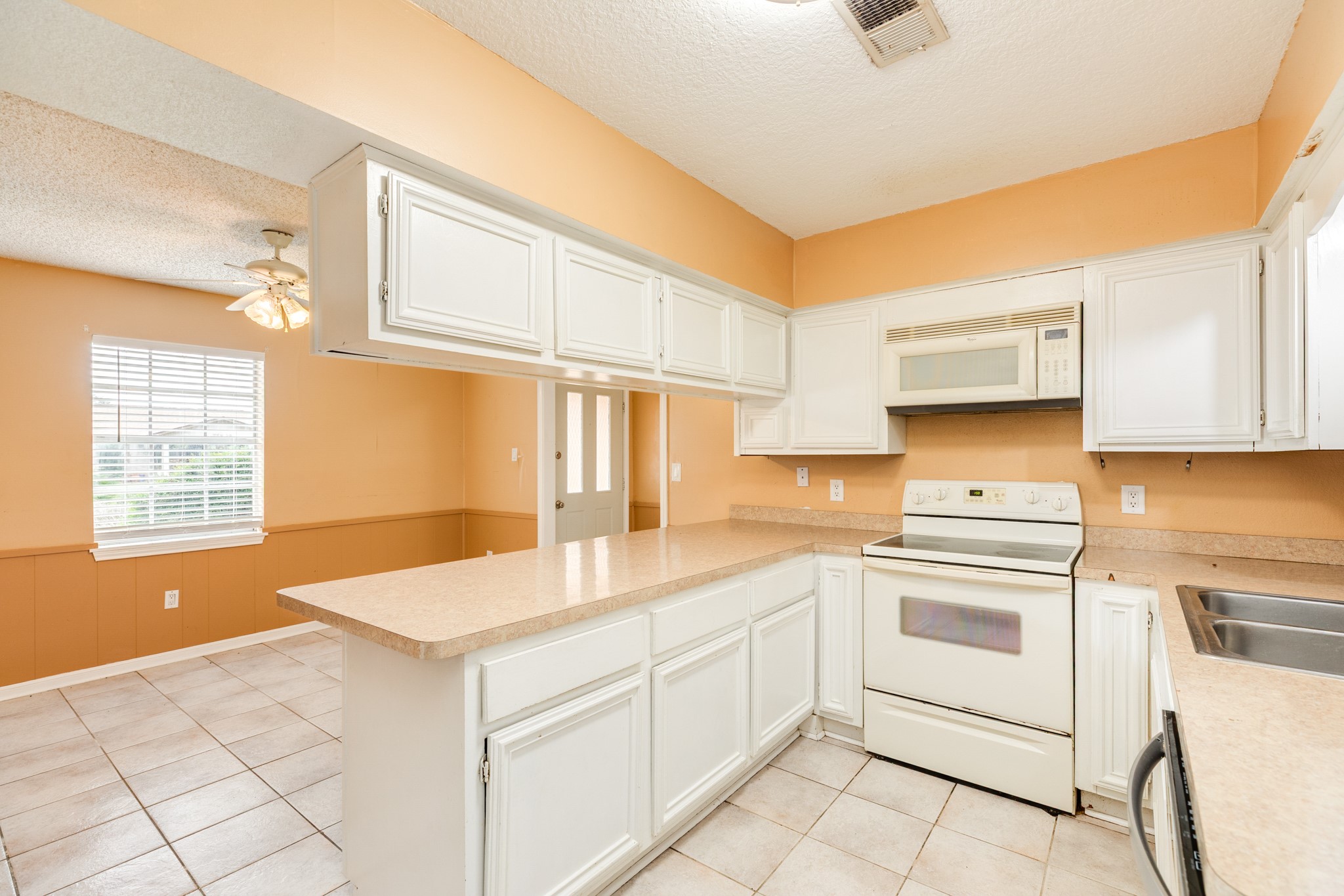 1030 Maple Street Clute, TX 77531 - Photo 9 of 25 a kitchen with granite countertop white cabinets and white appliances