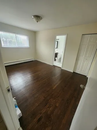 an empty room with wooden floor