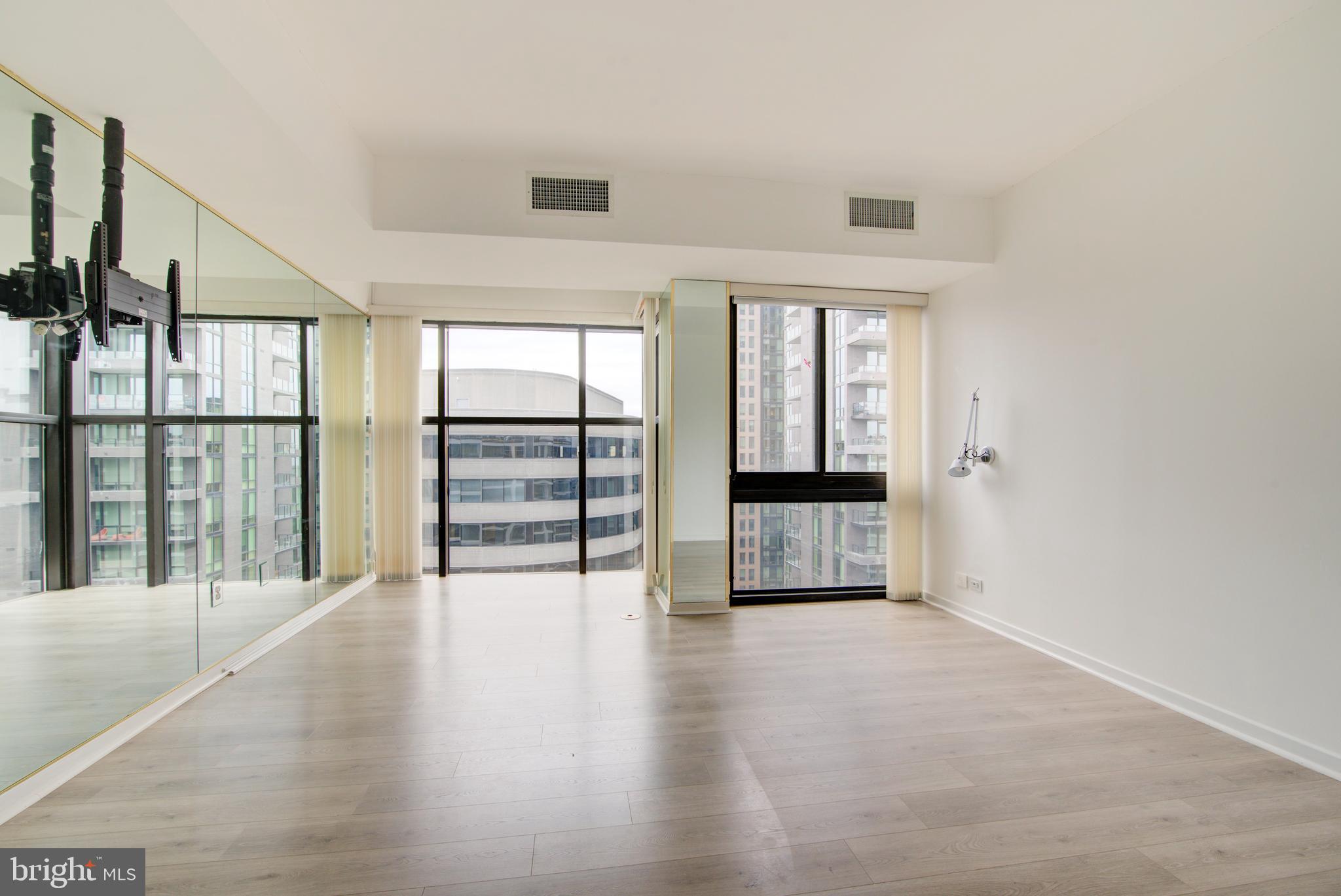 1530 Key Boulevard, Unit 1321 Arlington, VA 22209 - Photo 15 of 42 an empty room with wooden floor and windows