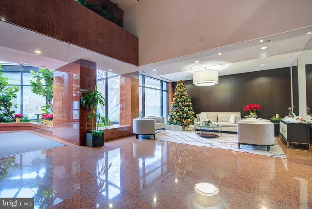 a view of a house with a potted plant and floor to ceiling window