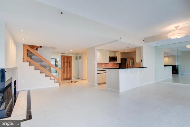 a kitchen with stainless steel appliances a sink stove and cabinets
