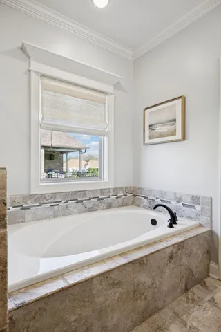 a bedroom with a large bed and a large window