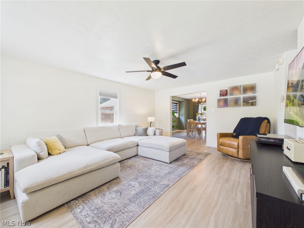 3490 County Line Road Madison, OH 44057 - Photo 5 of 42 Spacious living area featuring light wood-finish flooring and a contemporary ceiling fan