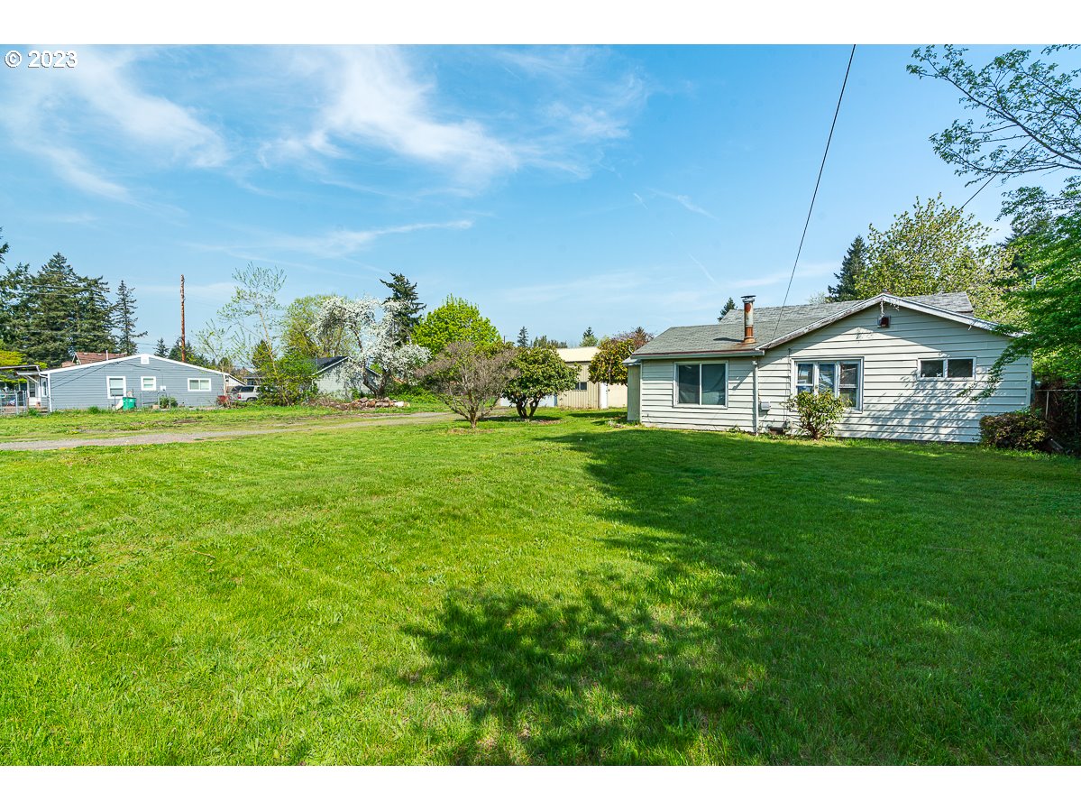 16315 Southeast Lincoln Street Portland, OR 97233 - Photo 4 of 32 a view of a house with a big yard
