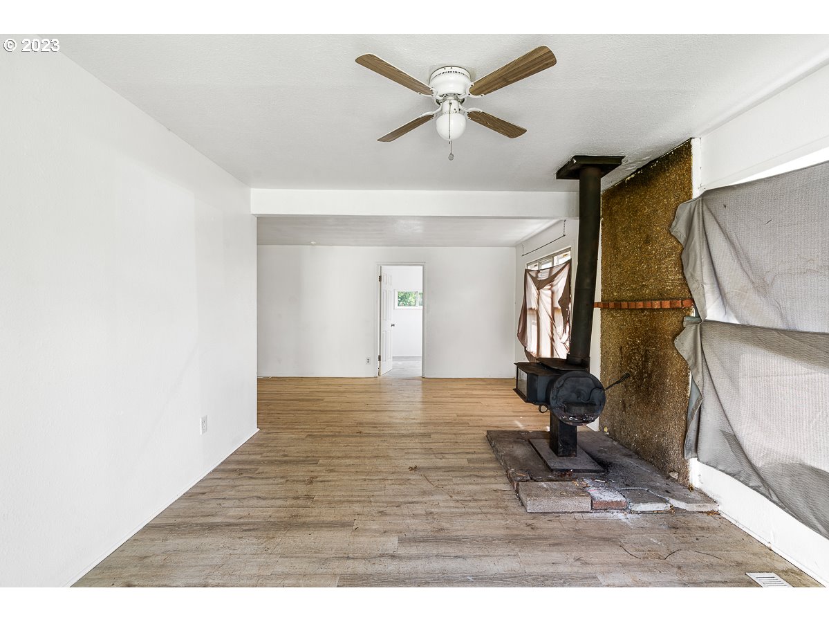 16315 Southeast Lincoln Street Portland, OR 97233 - Photo 5 of 32 a view of empty room with wooden floor and fan