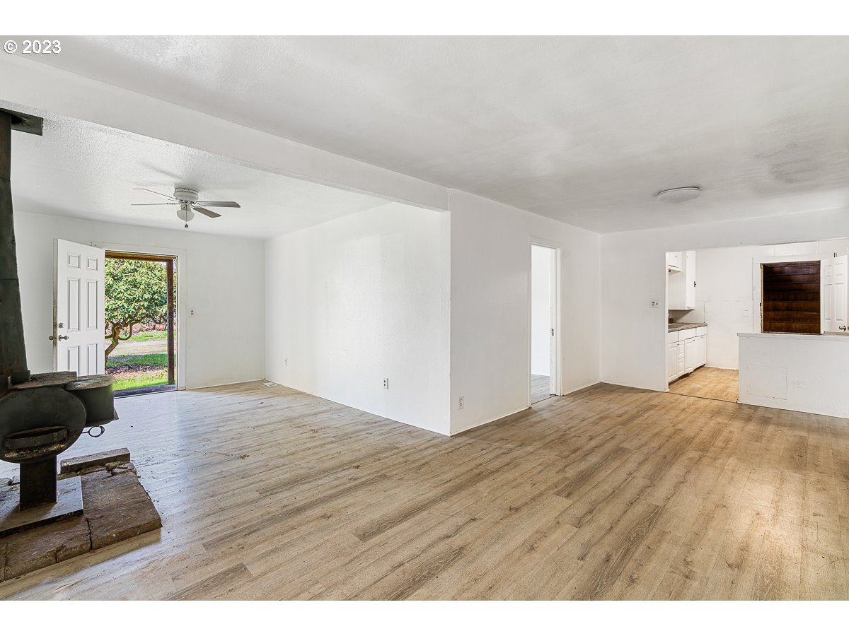 16315 Southeast Lincoln Street Portland, OR 97233 - Photo 6 of 32 a view of empty room with wooden floor and fan
