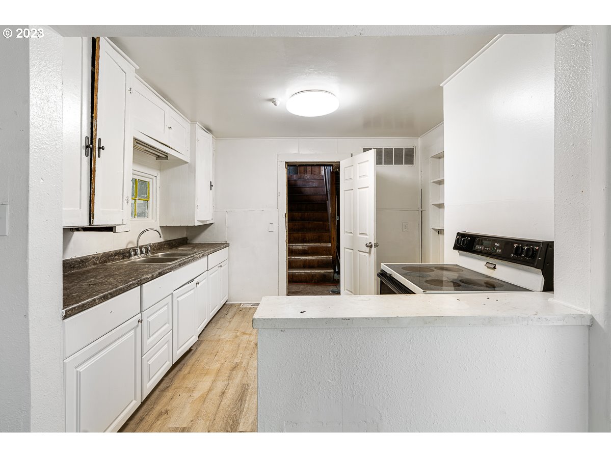 16315 Southeast Lincoln Street Portland, OR 97233 - Photo 7 of 32 a kitchen with stainless steel appliances granite countertop a sink and a refrigerator
