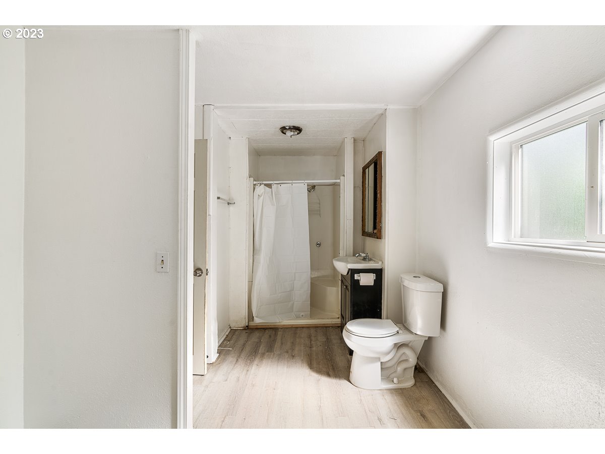 16315 Southeast Lincoln Street Portland, OR 97233 - Photo 8 of 32 a bathroom with a toilet sink and a mirror