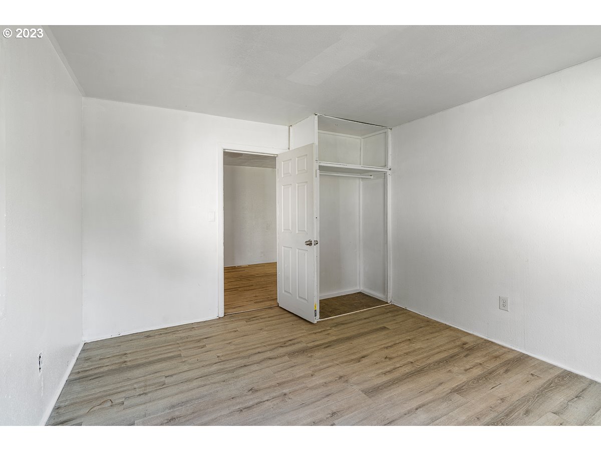 16315 Southeast Lincoln Street Portland, OR 97233 - Photo 9 of 32 a view of an empty room with wooden floor