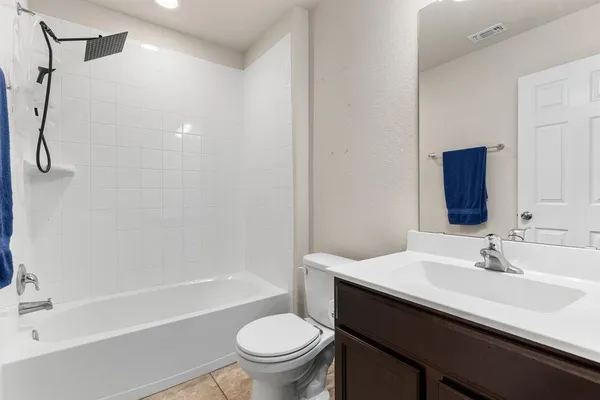 a bathroom with a sink toilet vanity and shower