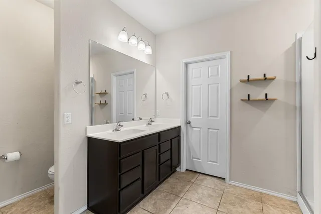 a bathroom with a sink vanity and a mirror