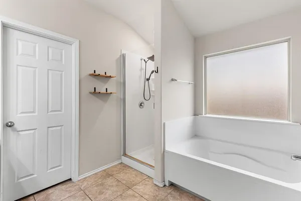 a bathroom with a bathtub and a shower