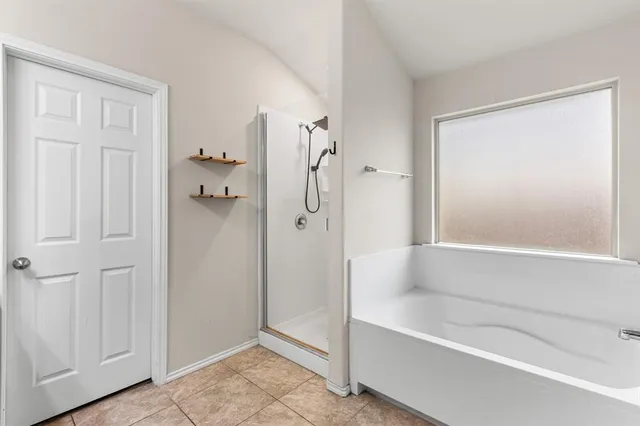 a bathroom with a bathtub and a shower