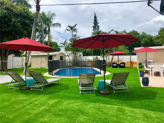 a view of a chair and table under an umbrella