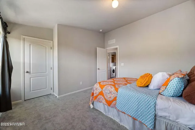 a bedroom with a bed and blue walk in closet