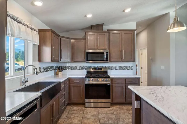 a kitchen with a sink stove and refrigerator