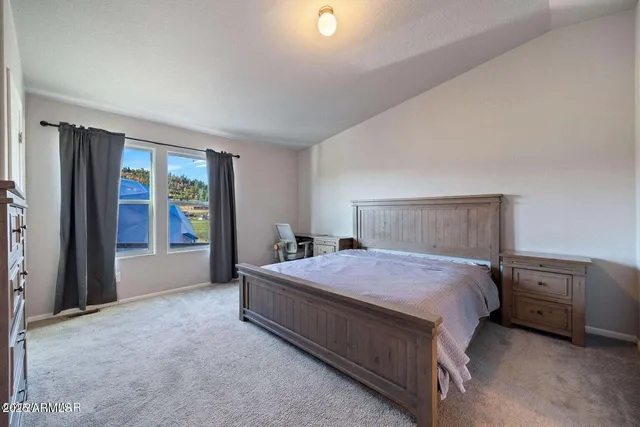 a bedroom with a bed and window