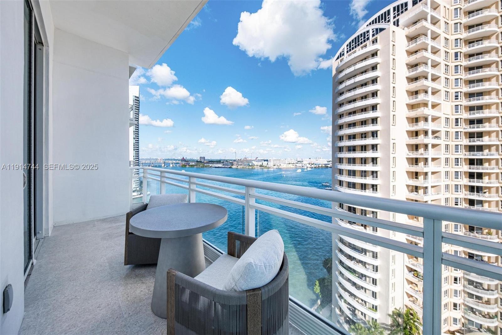 900 Brickell Key Boulevard, Unit 1403 Miami, FL 33131 - Photo 13 of 29 a view of a balcony with chair and tables