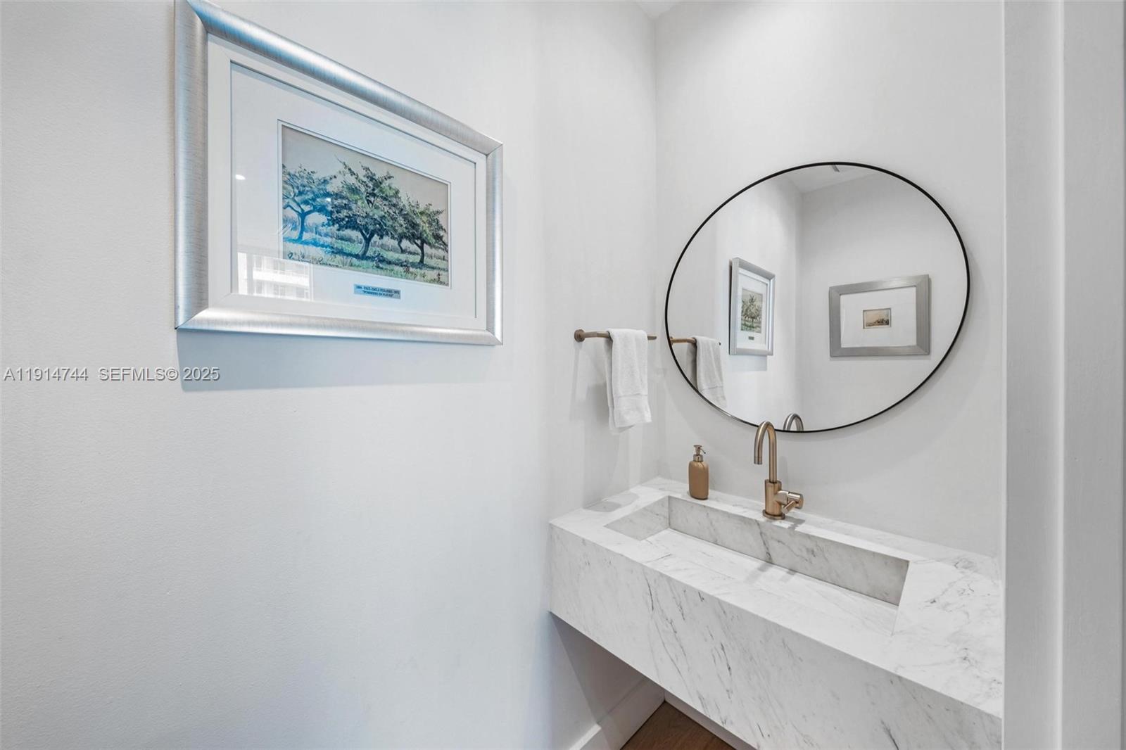 900 Brickell Key Boulevard, Unit 1403 Miami, FL 33131 - Photo 24 of 29 a bathroom with a sink and a mirror