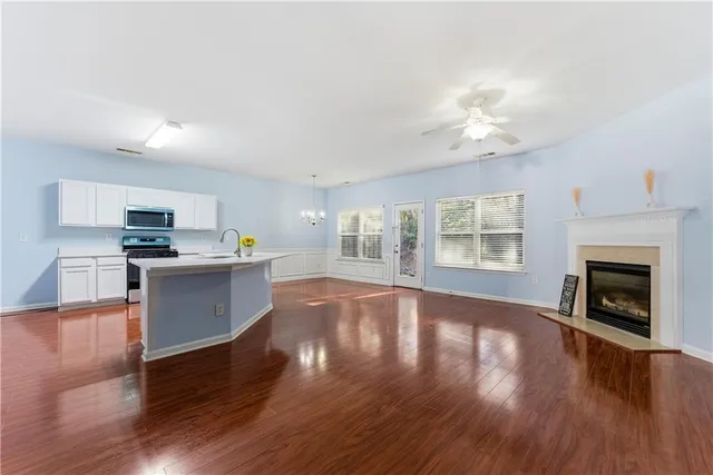 a open kitchen with cabinets and wooden floor