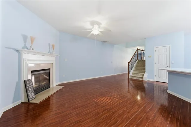 a view of a livingroom with wooden floor and a fireplace