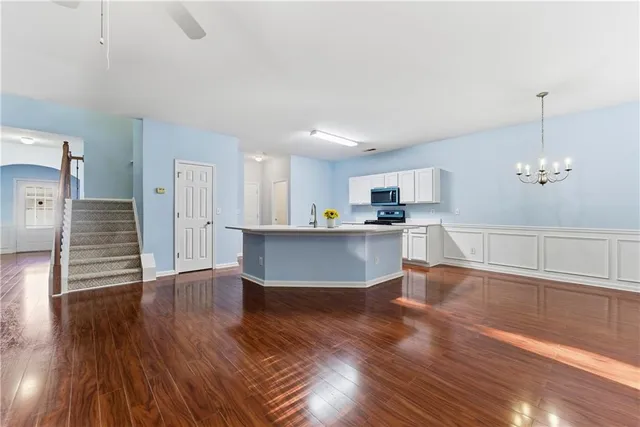 a view of a kitchen with wooden floor and a sink