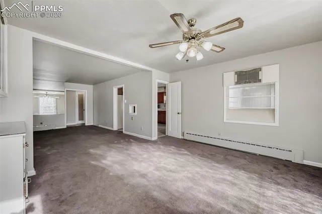 an empty room with closet and windows