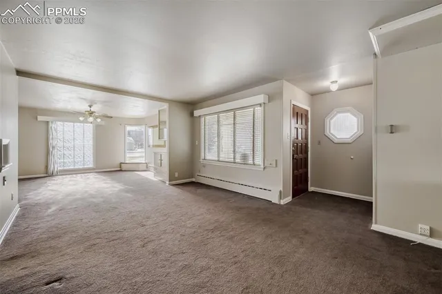 an empty room with windows and closet