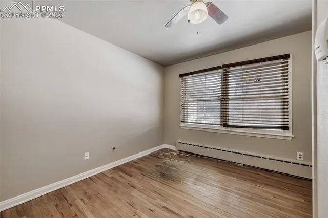 wooden floor in an empty room with a window