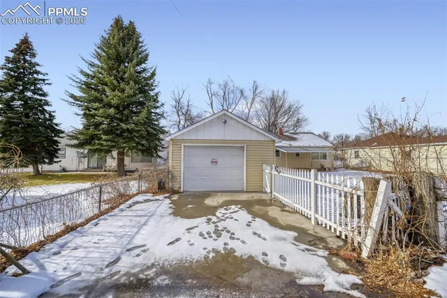 a front view of a house with a yard and lake view