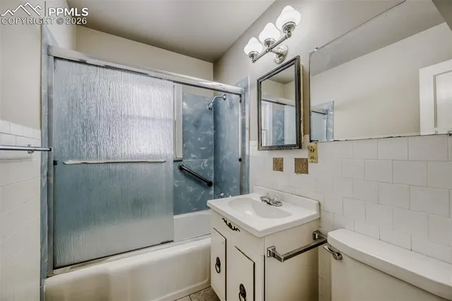 a bathroom with a sink a mirror and a shower