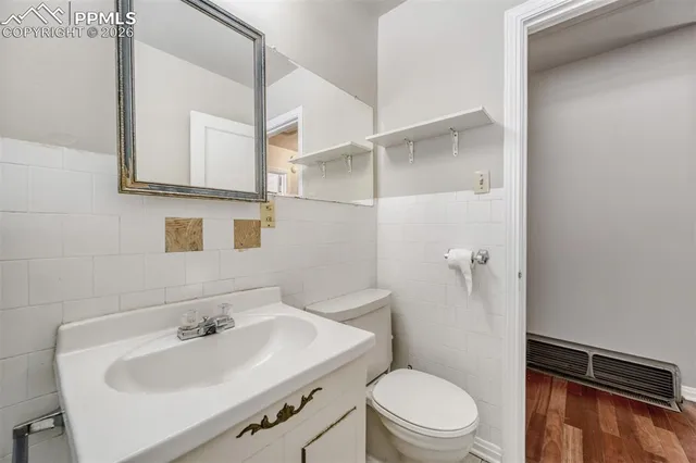 a bathroom with a sink toilet and mirror