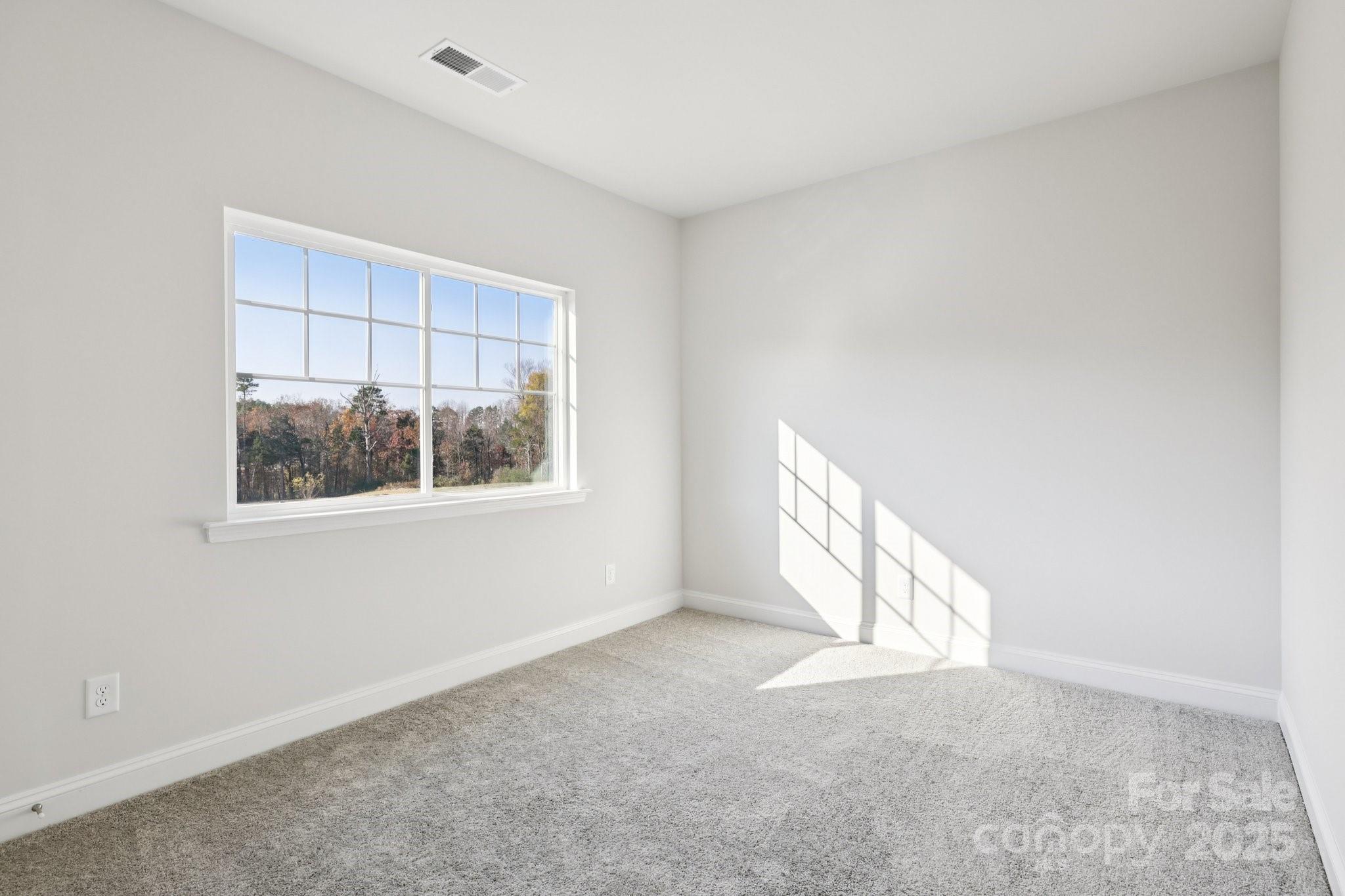 9612 Pointer Road, Unit 59 Huntersville, NC 28078 - Photo 24 of 43 a view of an empty room with a window