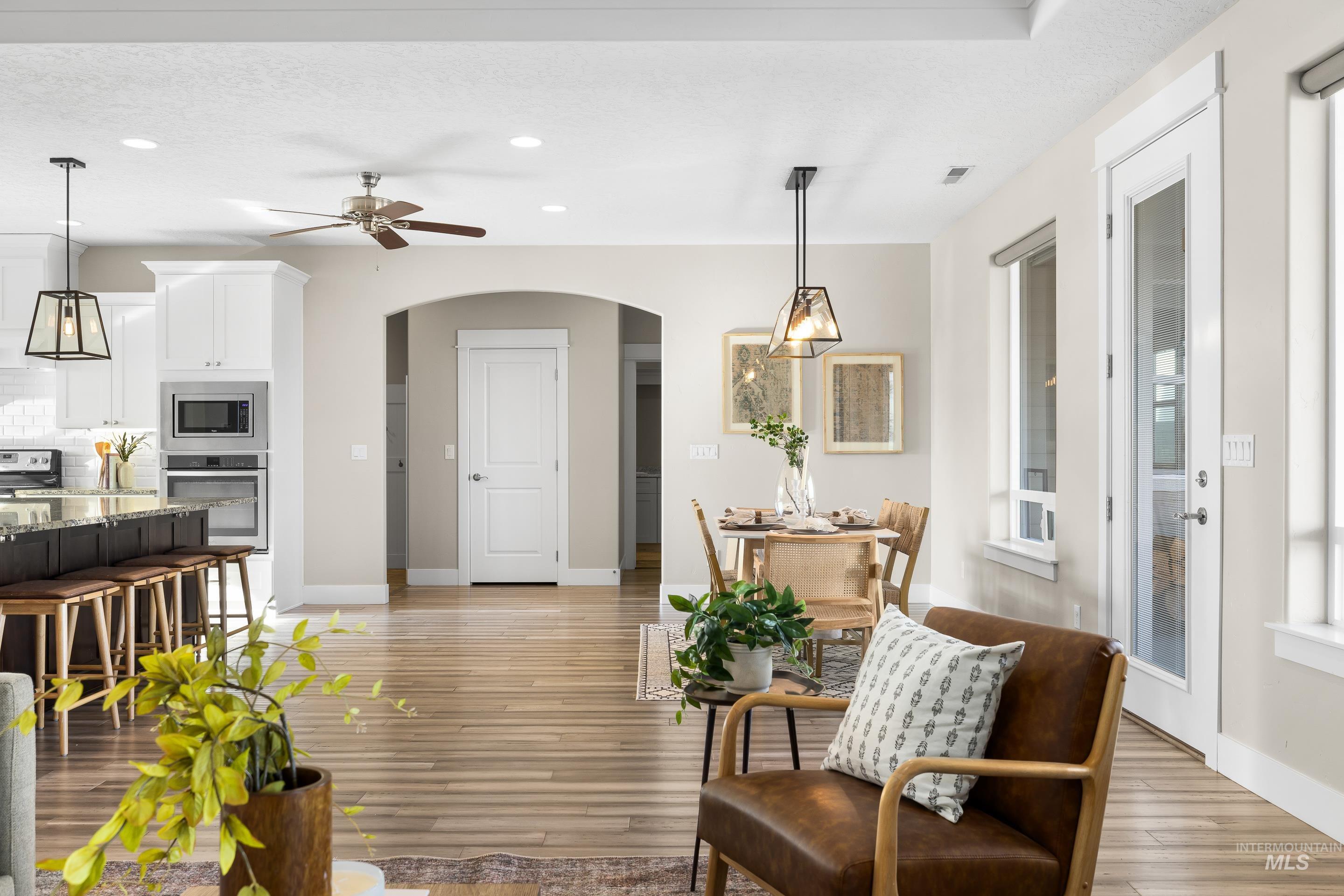 8018 Plumberry Court Middleton, ID 83644 - Photo 12 of 50 Living room with arched walkways, light wood-style flooring, a ceiling fan, and recessed lighting