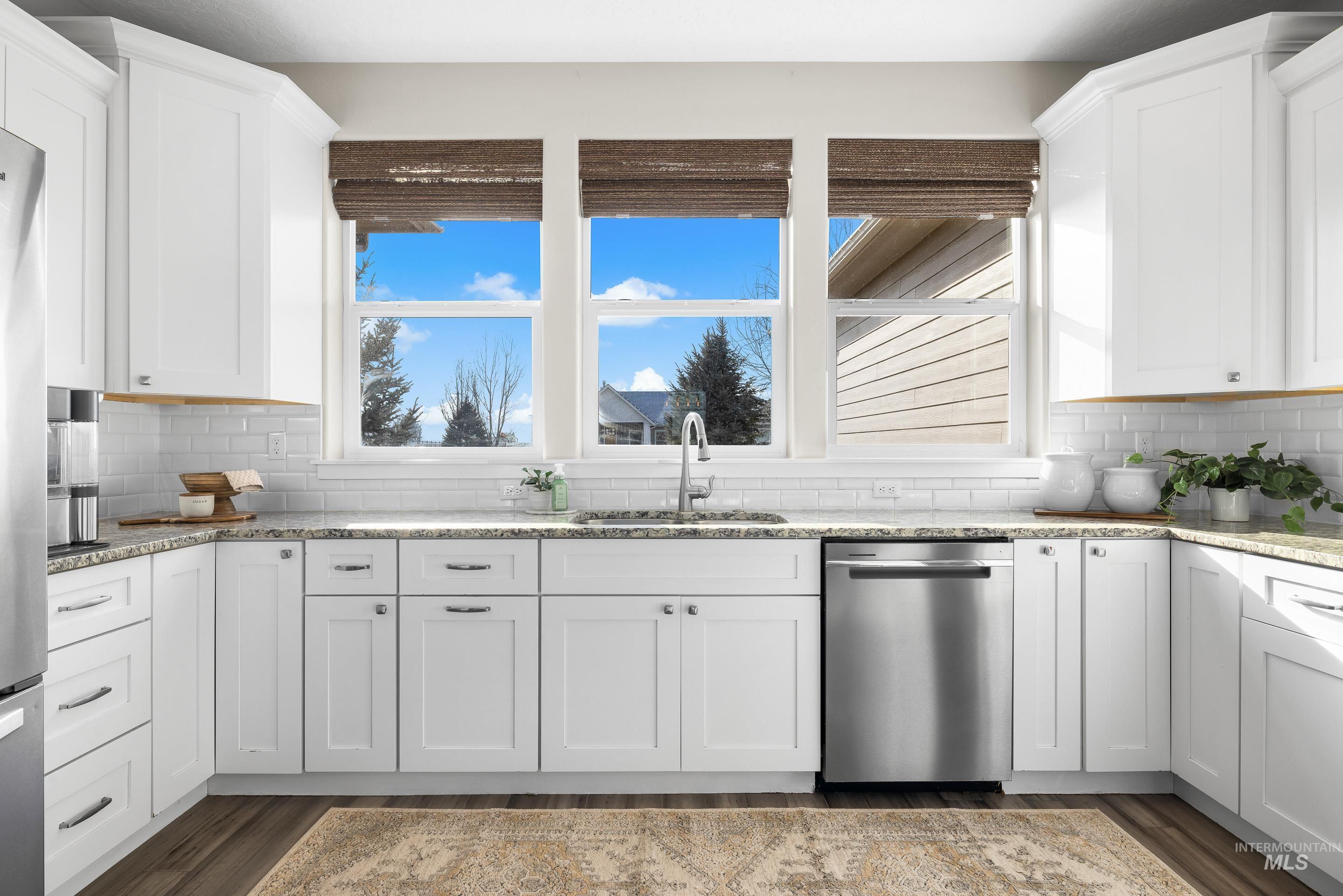 8018 Plumberry Court Middleton, ID 83644 - Photo 20 of 50 Kitchen with tasteful backsplash, appliances with stainless steel finishes, and light stone counters