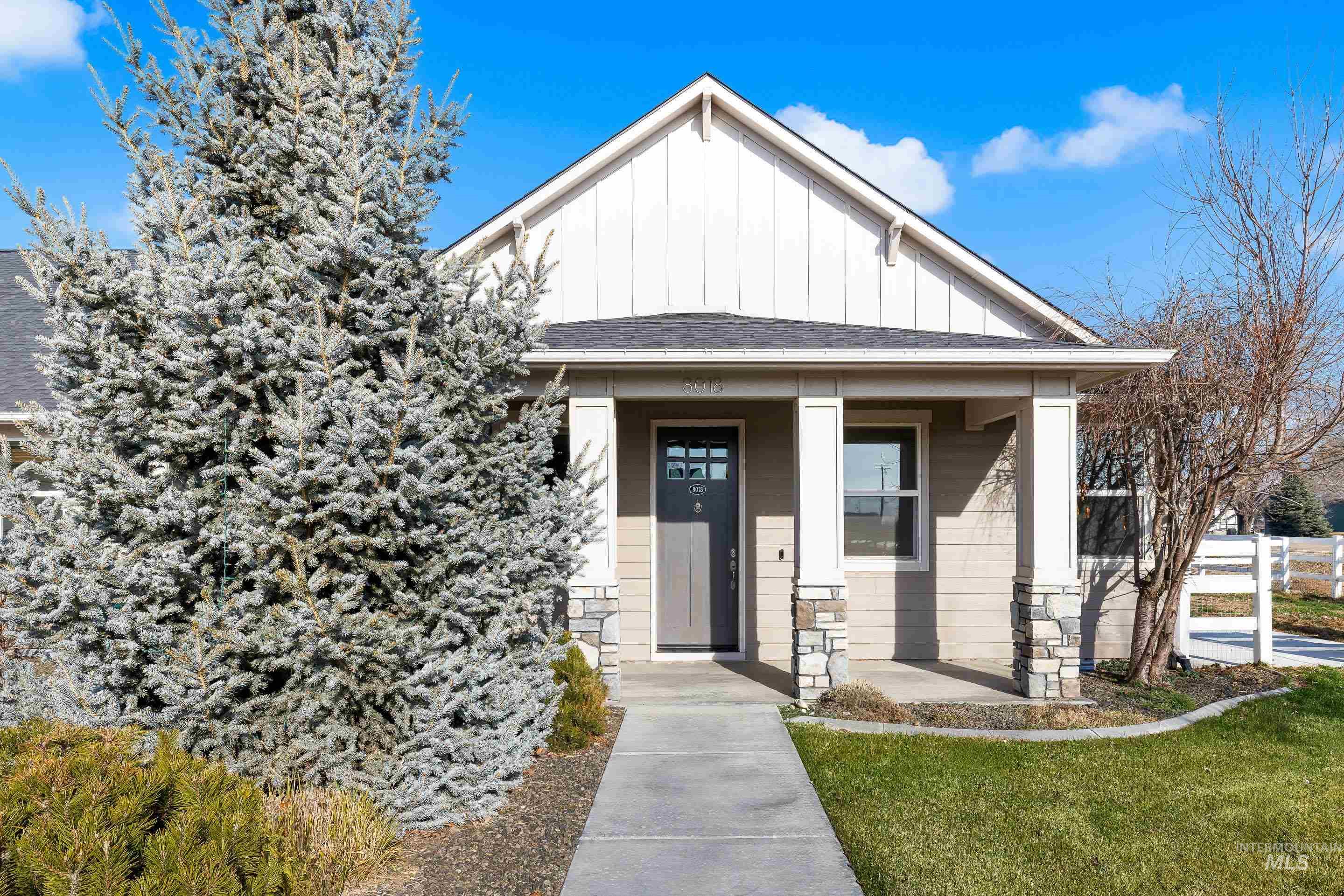 8018 Plumberry Court Middleton, ID 83644 - Photo 3 of 50 View of front facade featuring board and batten siding, covered porch, and a front yard