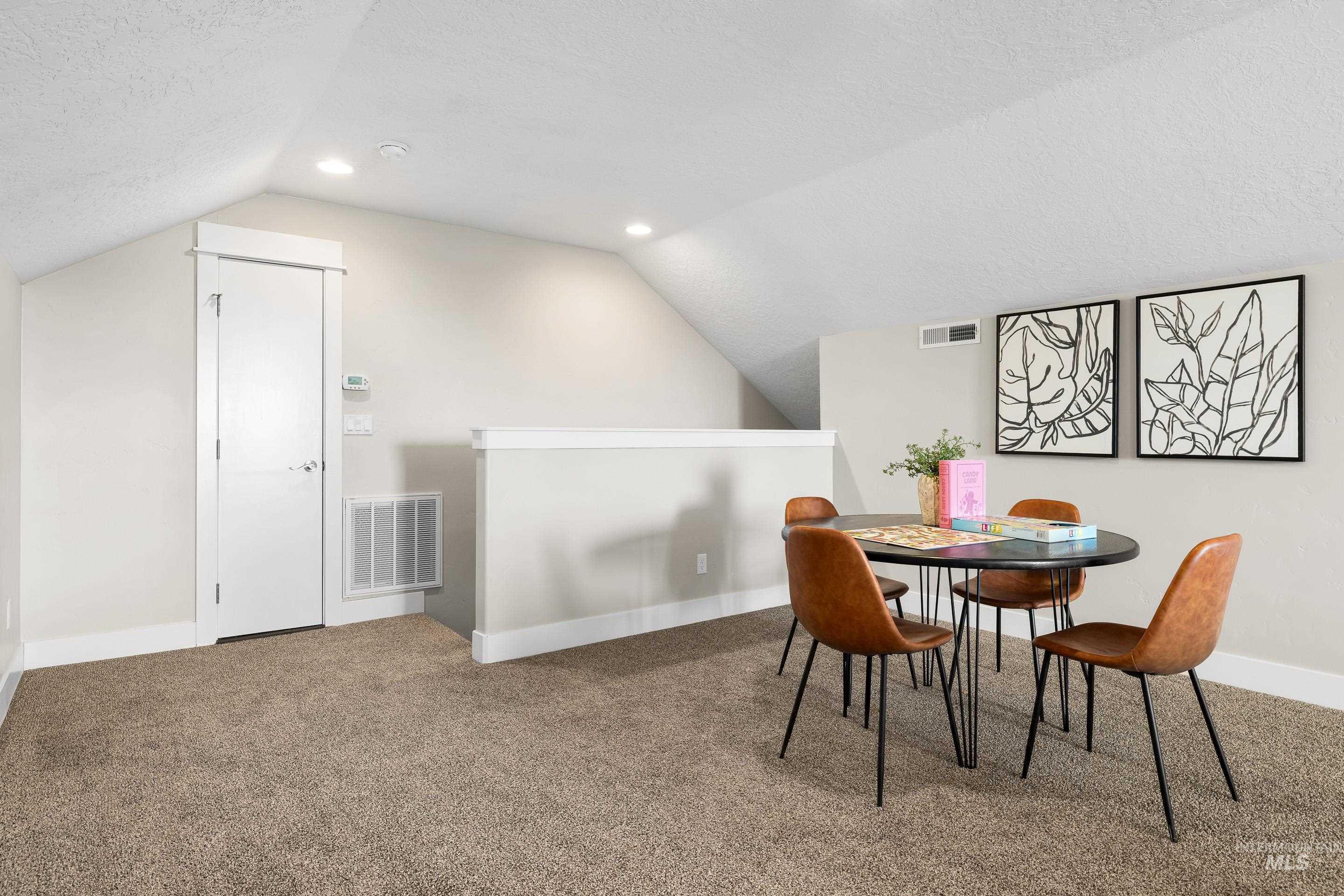 8018 Plumberry Court Middleton, ID 83644 - Photo 38 of 50 Dining area featuring vaulted ceiling, carpet floors, a textured ceiling, and recessed lighting