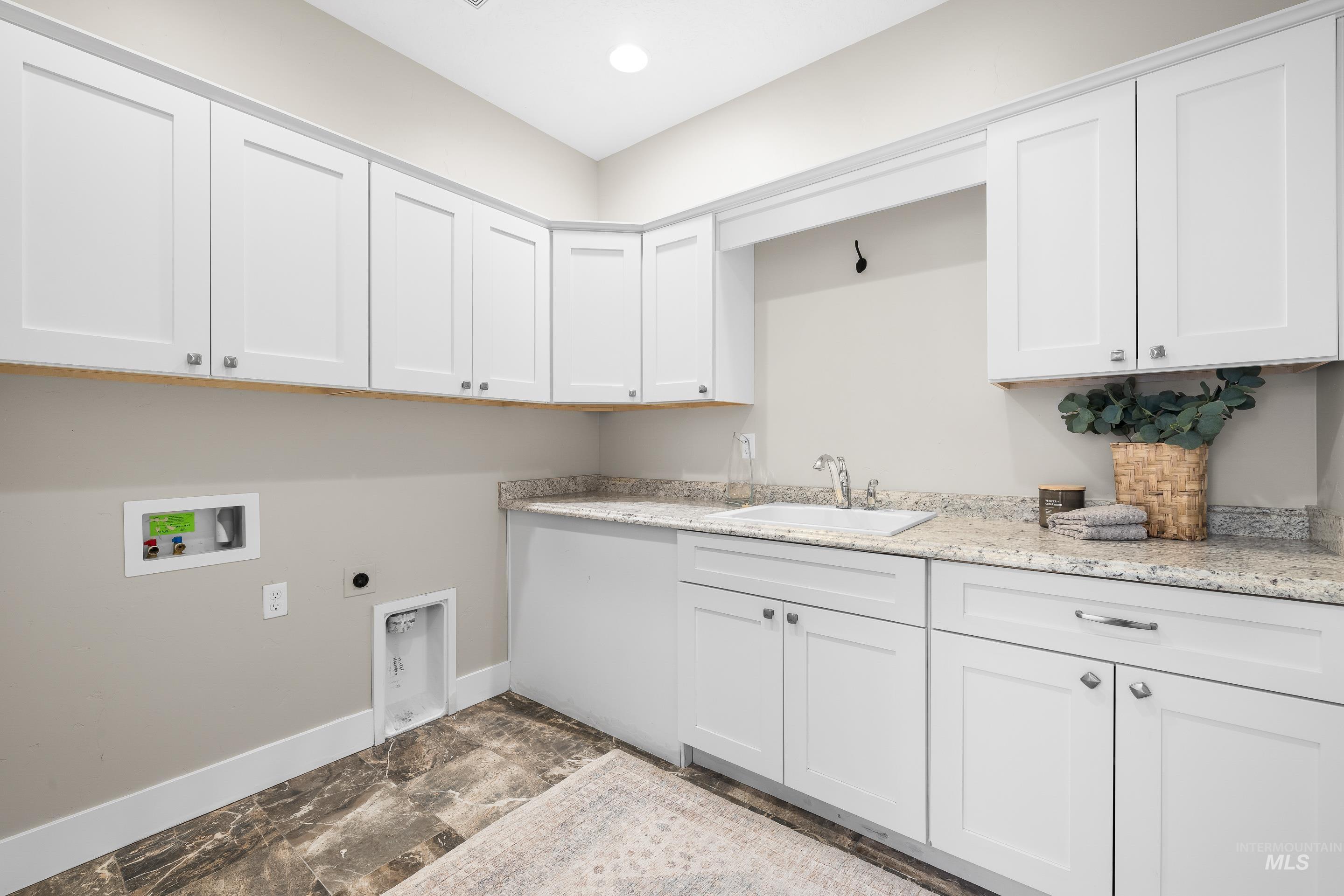 8018 Plumberry Court Middleton, ID 83644 - Photo 43 of 50 Laundry room featuring cabinet space, electric dryer hookup, and washer hookup