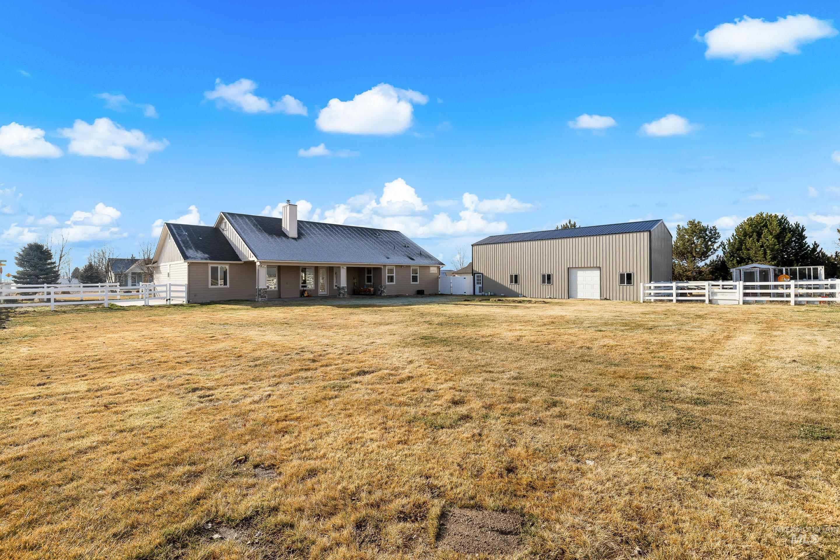 8018 Plumberry Court Middleton, ID 83644 - Photo 49 of 50 Back of property featuring a pole building, an outbuilding, a chimney, and a metal roof