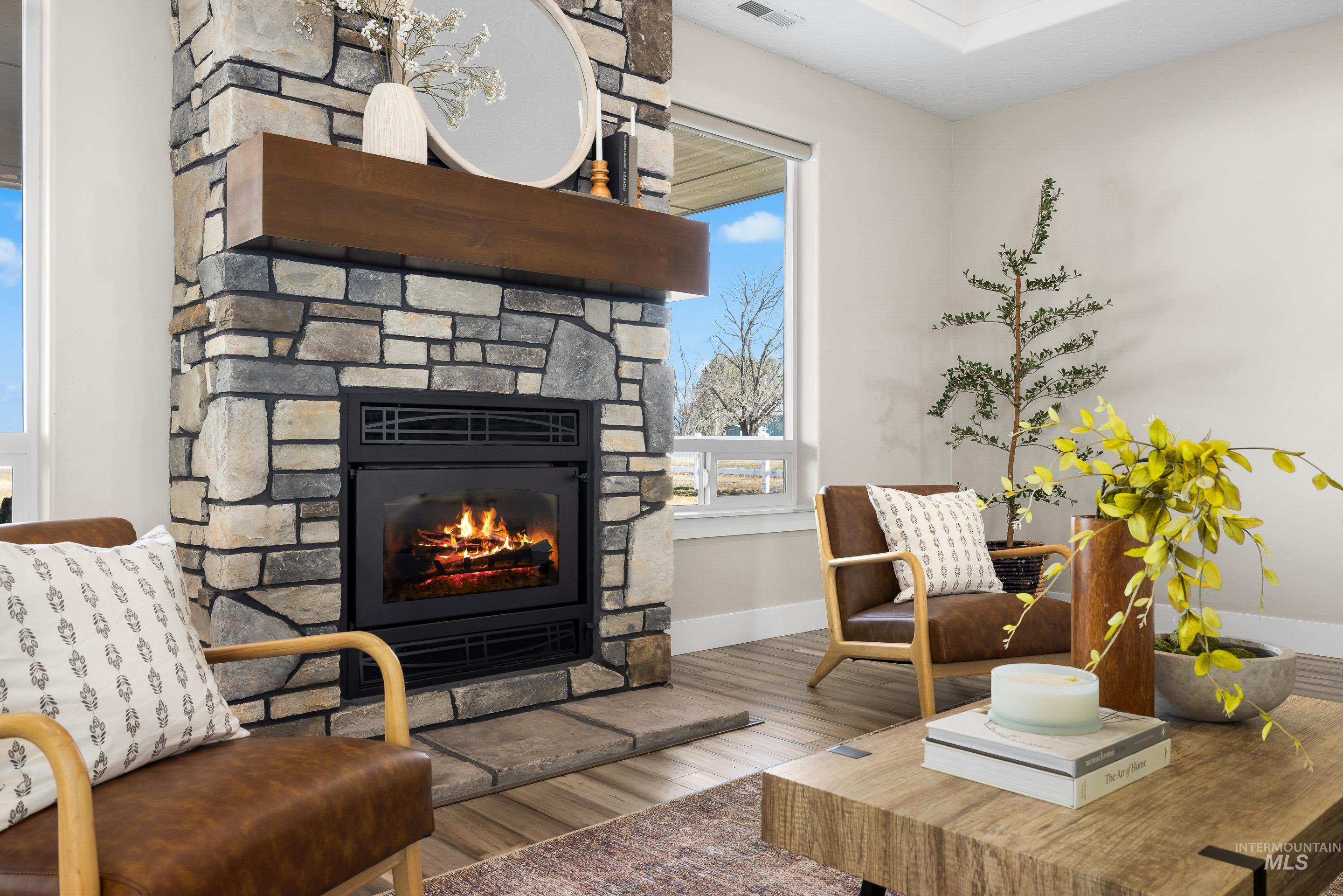 8018 Plumberry Court Middleton, ID 83644 - Photo 10 of 50 Sitting room featuring a fireplace and wood finished floors
