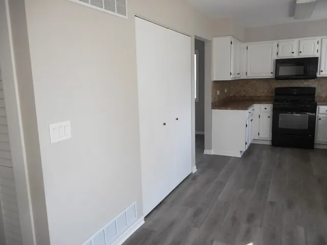 a view of empty room with a fireplace