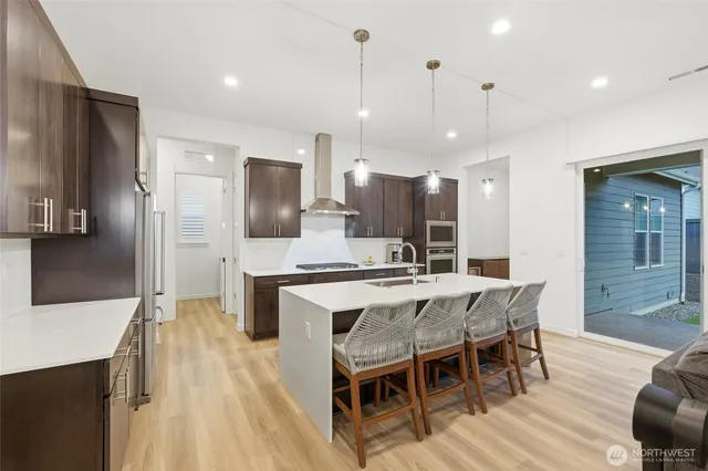 a large kitchen with a table and chairs